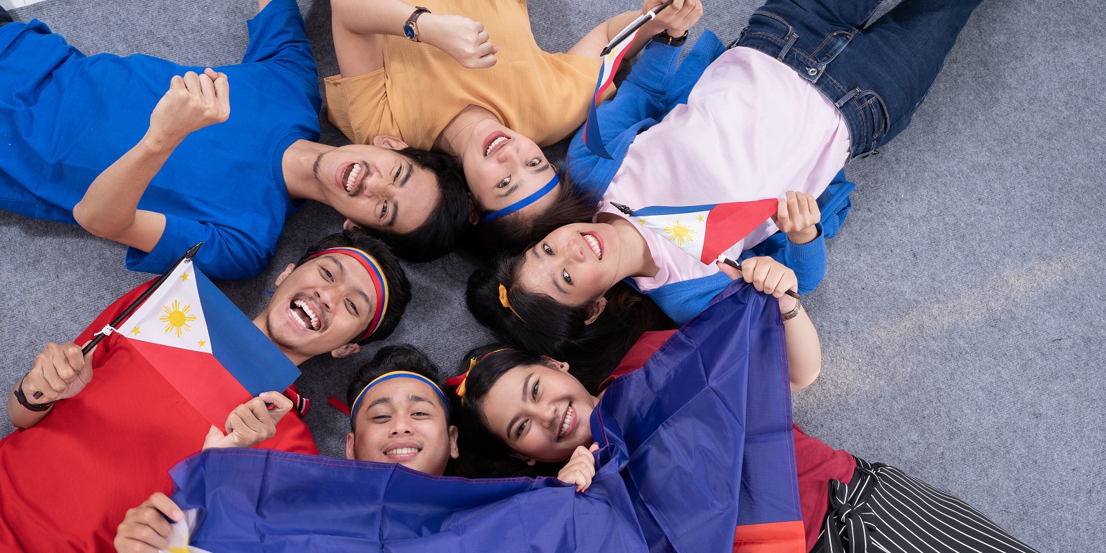 people holding philippines flag celebrating independence day